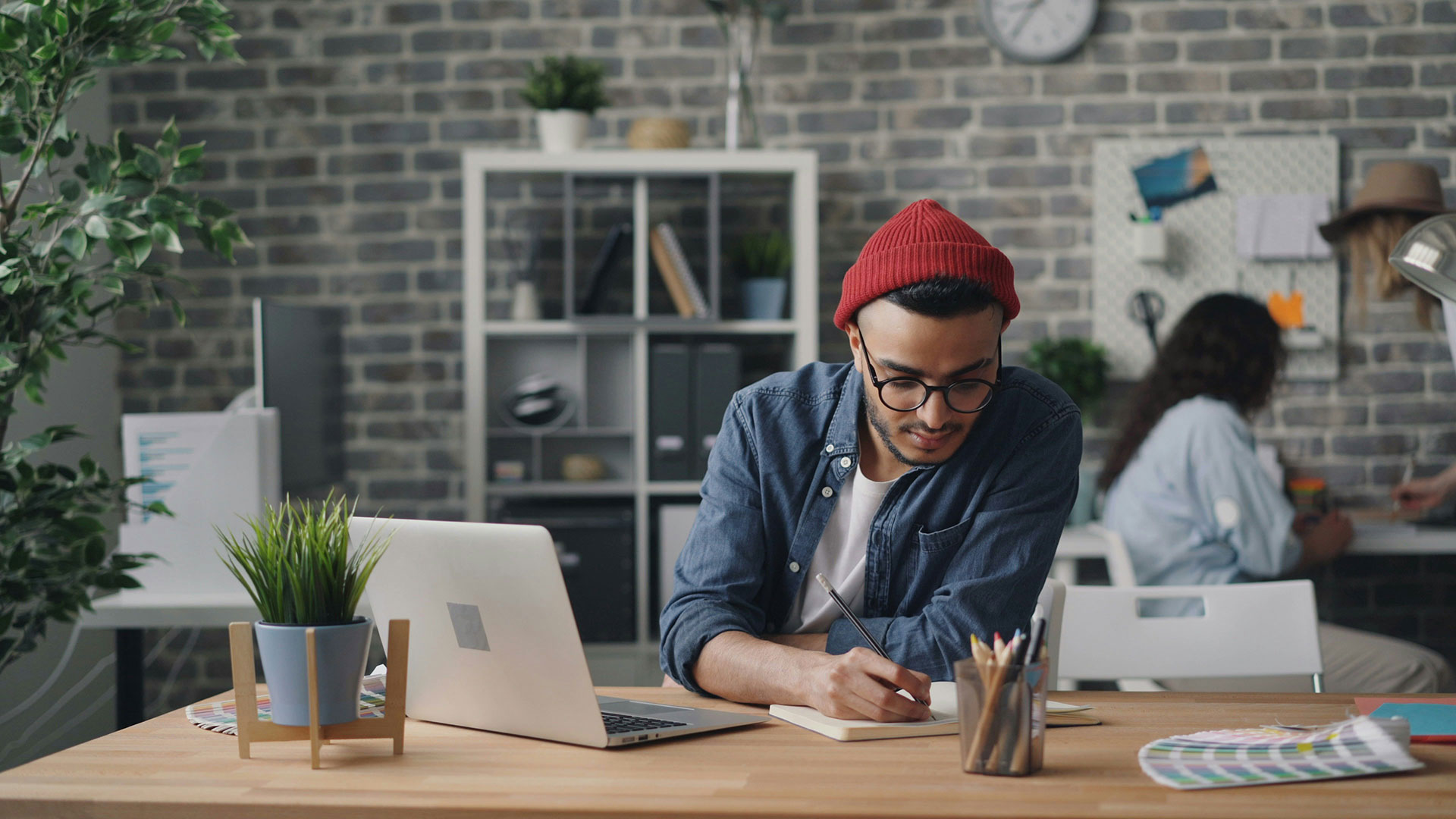 Man working at desk with laptop and coffee